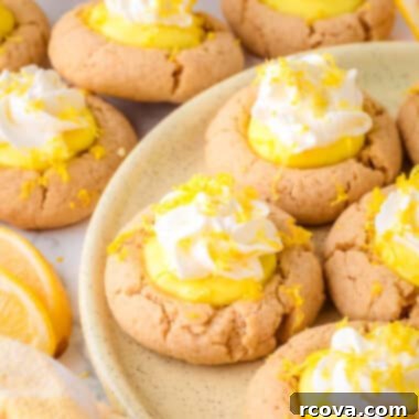 Sunshine Lemon Pie Cookies 5 lemon pie cookies on a plate, featuring the golden cookie, lemon filling, and whipped cream