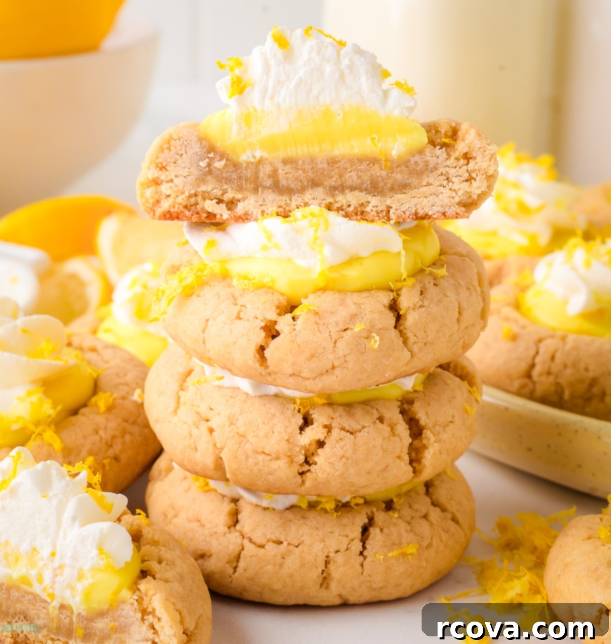Sunshine Lemon Pie Cookies 6 Lemon pie cookie cut in half, revealing the delicate layers of buttery cookie, zesty lemon pudding, and fluffy whipped cream