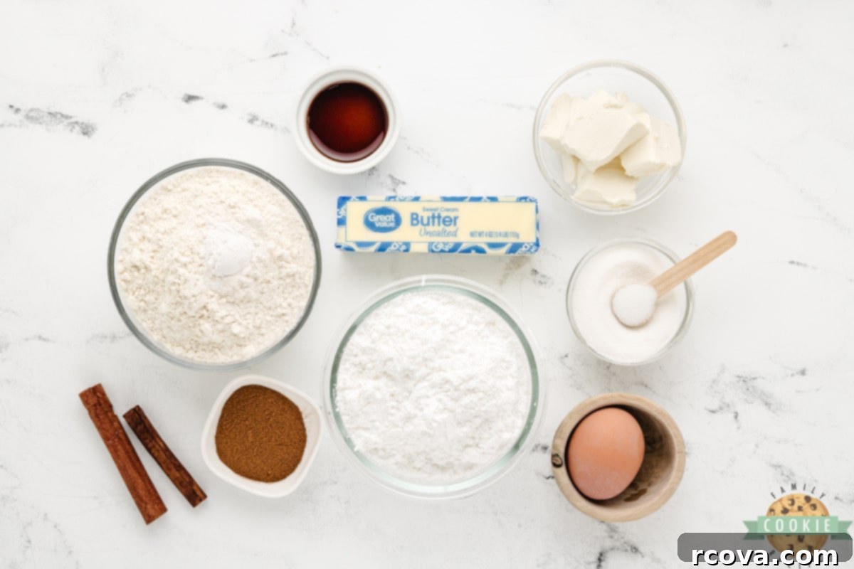 Creamy Snickerdoodle Delights 5 A flat lay photograph displaying all the ingredients needed to make Cream Cheese Snickerdoodle Cookies, including butter, cream cheese, powdered sugar, flour, and cinnamon sugar topping.