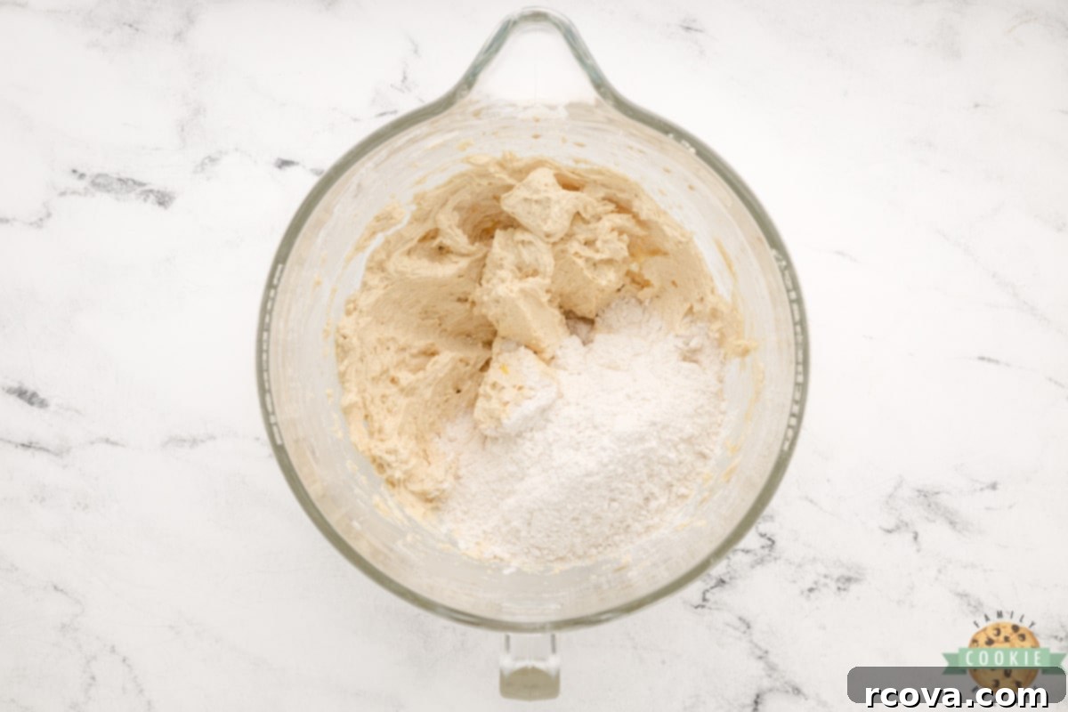 Irresistible Snickerdoodle Cookie Bars 11 Add flour and salt to cookie dough.