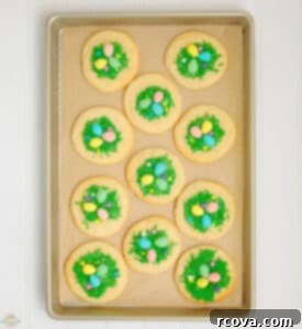 Sweet & Simple Easter Sugar Cookies 6 Easter sugar cookies on a baking sheet being pressed to create a nest