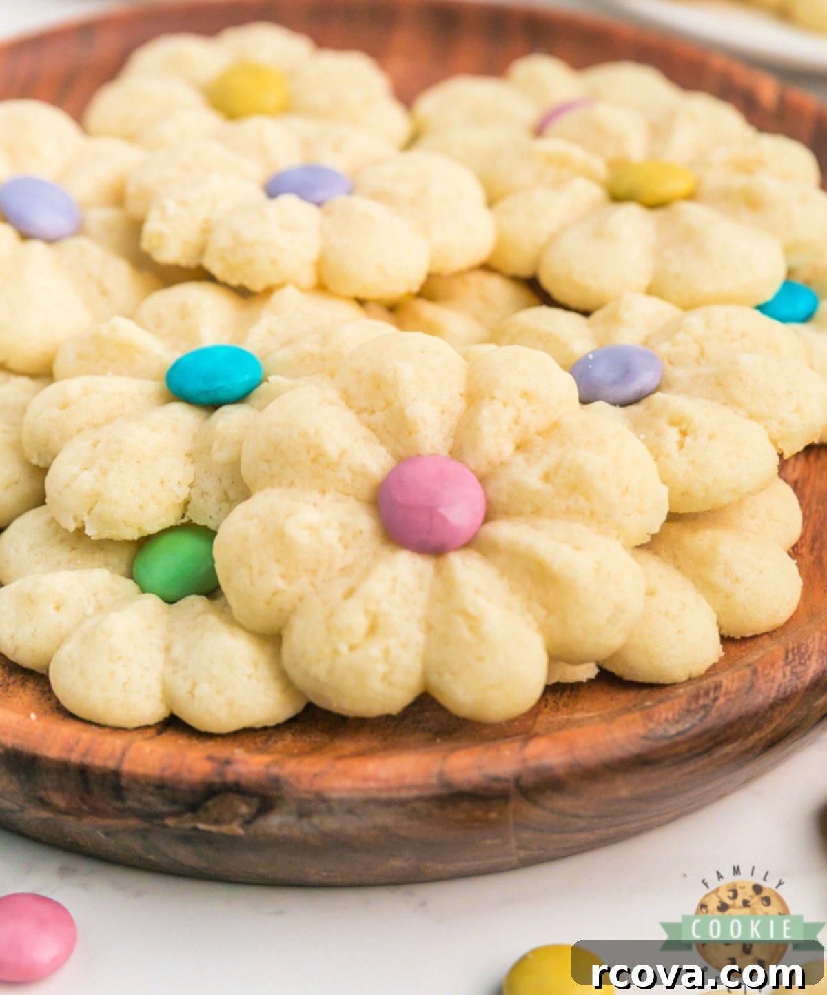 Buttery Spring Spritz Delights 2 Delicious Spring Spritz Cookies arranged beautifully, showcasing their soft, buttery texture and colorful M&M centers. Perfect for spring baking and celebrations.