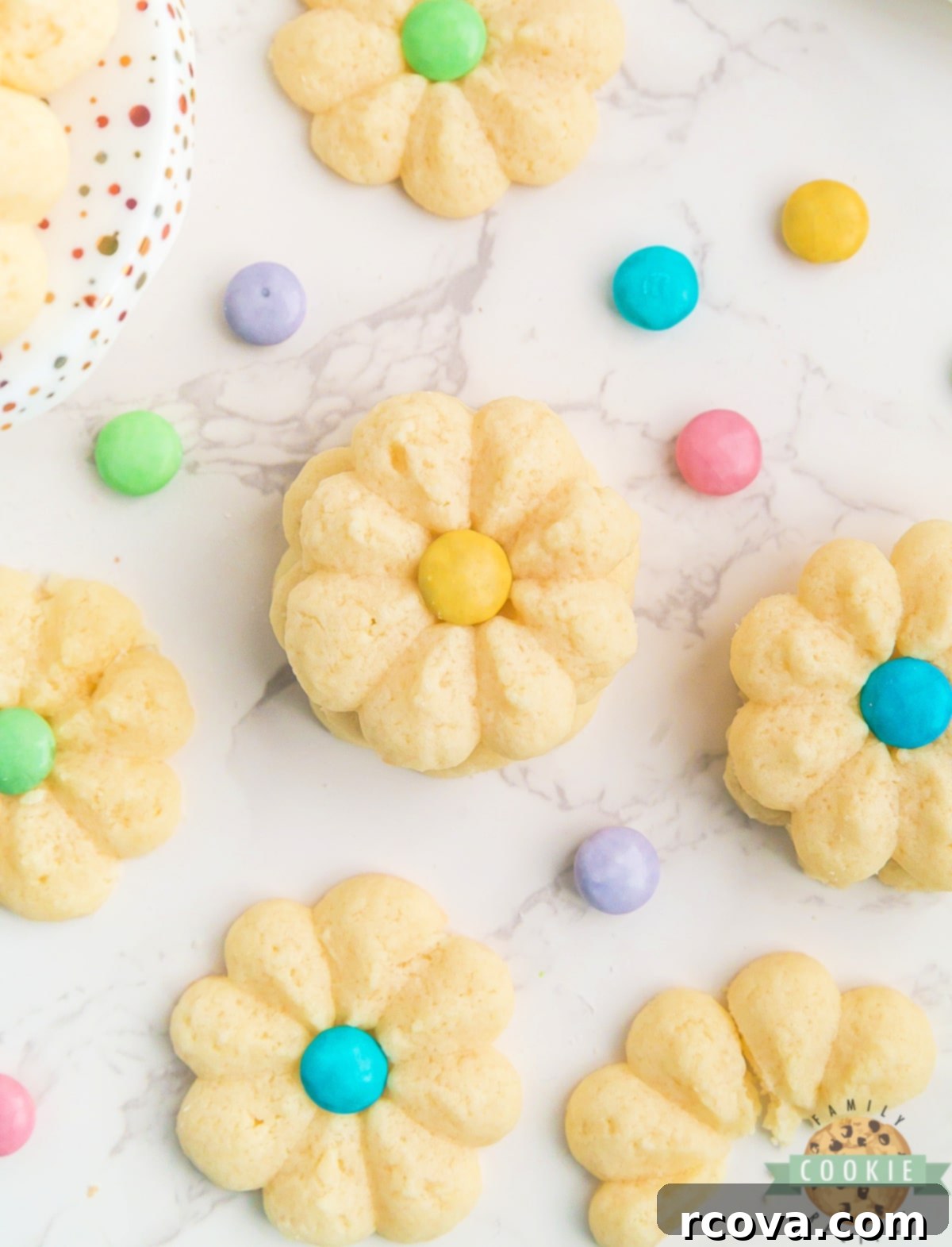Buttery Spring Spritz Delights 3 Close-up of simple shortbread flower cookies with colorful M&M centers, ready for a spring celebration.