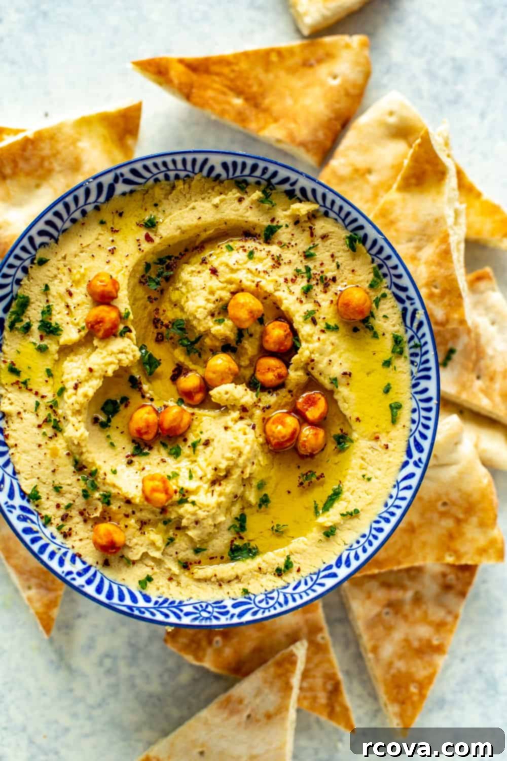 Healthy 5-Ingredient Meals for Breakfast Lunch and Dinner 19 A creamy bowl of The Easiest Instant Pot Hummus, drizzled with olive oil and sprinkled with paprika, served with warm pita bread for dipping.