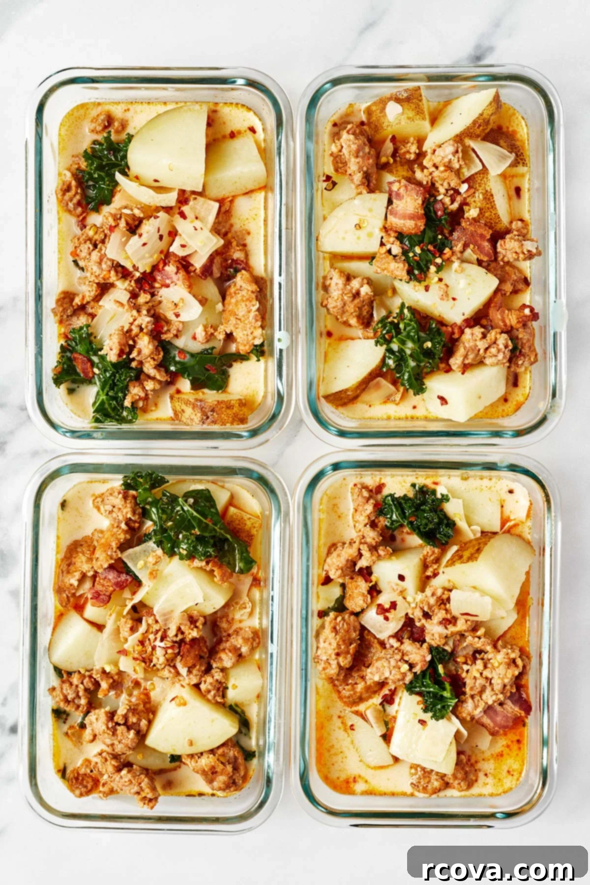 One Pot Restaurant-Style Zuppa Toscana 8 Four individual meal prep containers neatly filled with creamy Zuppa Toscana, demonstrating its suitability for batch cooking and future meals.