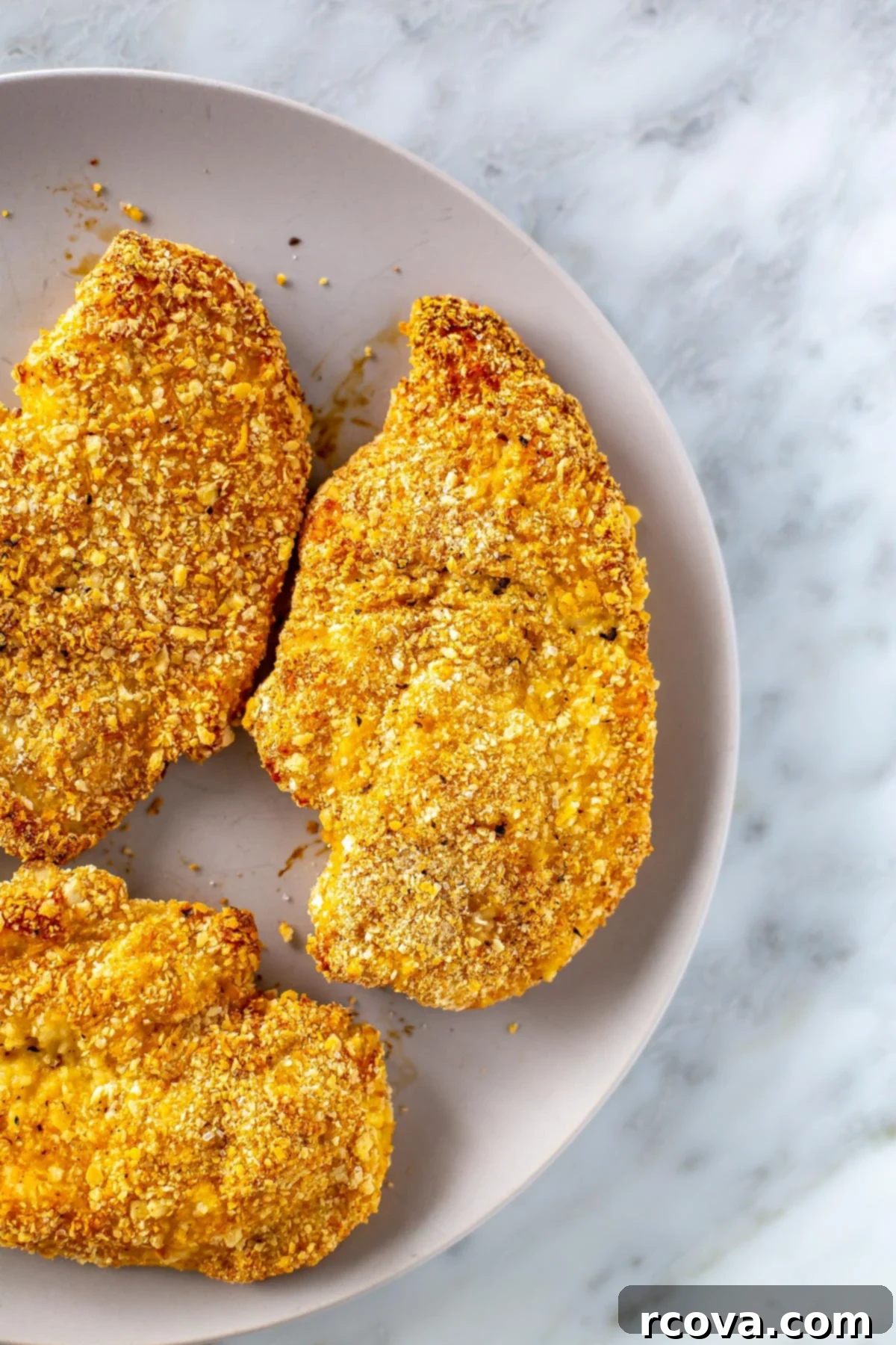 Crispy and Juicy Oven Baked Chicken Cutlets 6 A close-up view of three beautifully breaded chicken cutlets, perfectly coated and ready for baking to achieve a golden, crispy finish.
