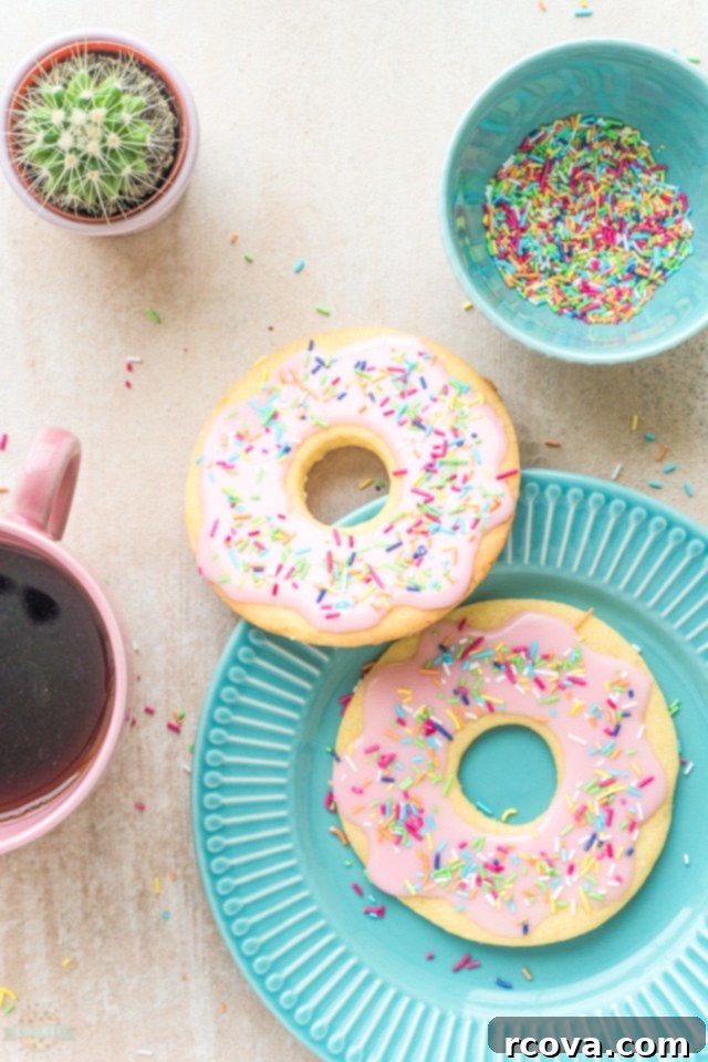 Rosy Donut Delights 8 A stack of beautifully glazed pink donut cookies with sprinkles, highlighting their cute and appealing design.