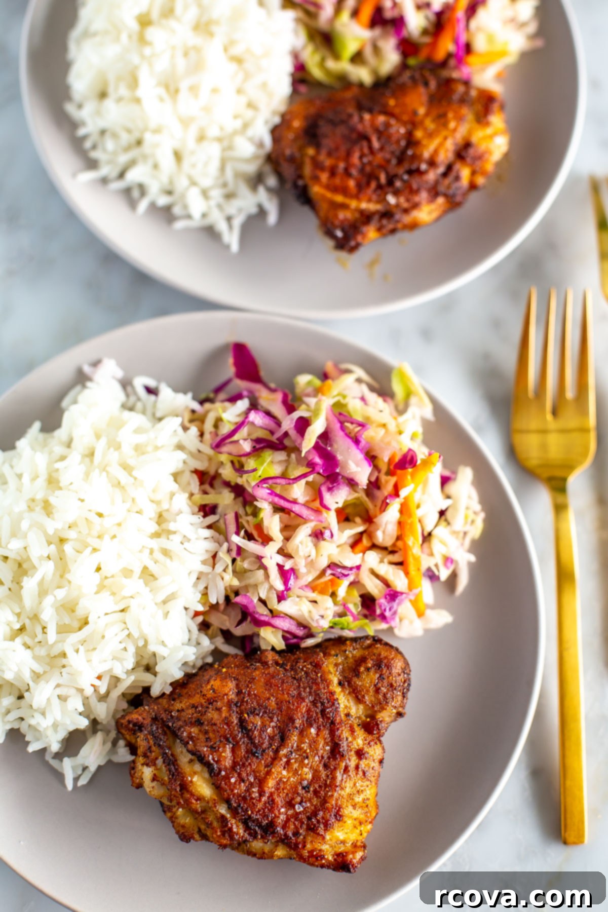 Versatile Air Fryer Chicken Thighs Bone In Or Boneless 6 A perfectly plated meal featuring crispy air-fried chicken thighs, a generous portion of white rice, and a fresh coleslaw side, ready to be enjoyed.