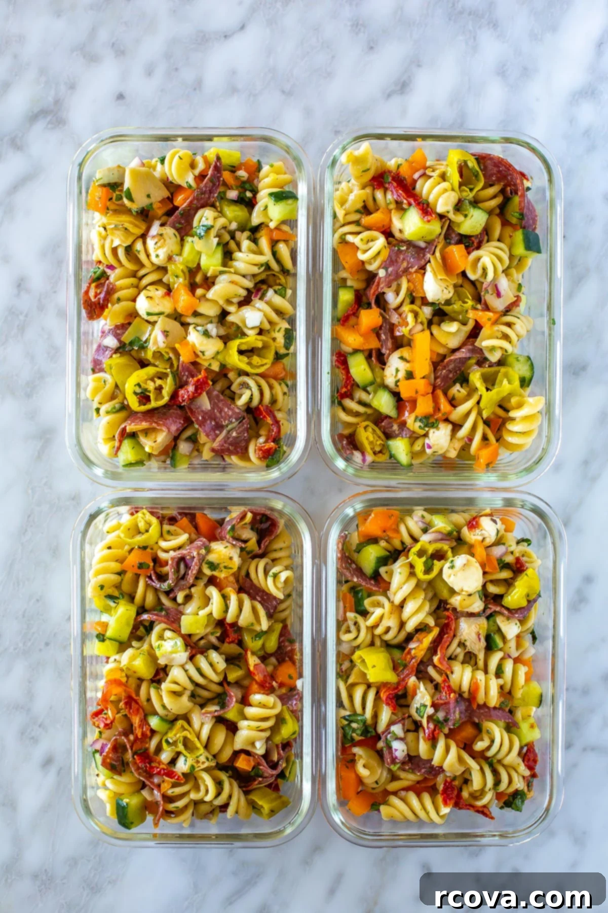 The Ultimate Italian Pasta Salad 8 Four meal prep containers, each filled with Italian pasta salad.