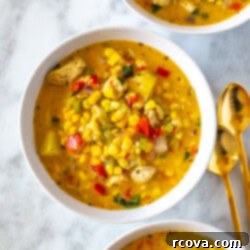 Easy Creamy Chicken Corn Chowder 10 Three bowls each filled with chicken corn chowder, garnished with fresh herbs and a sprinkle of paprika.