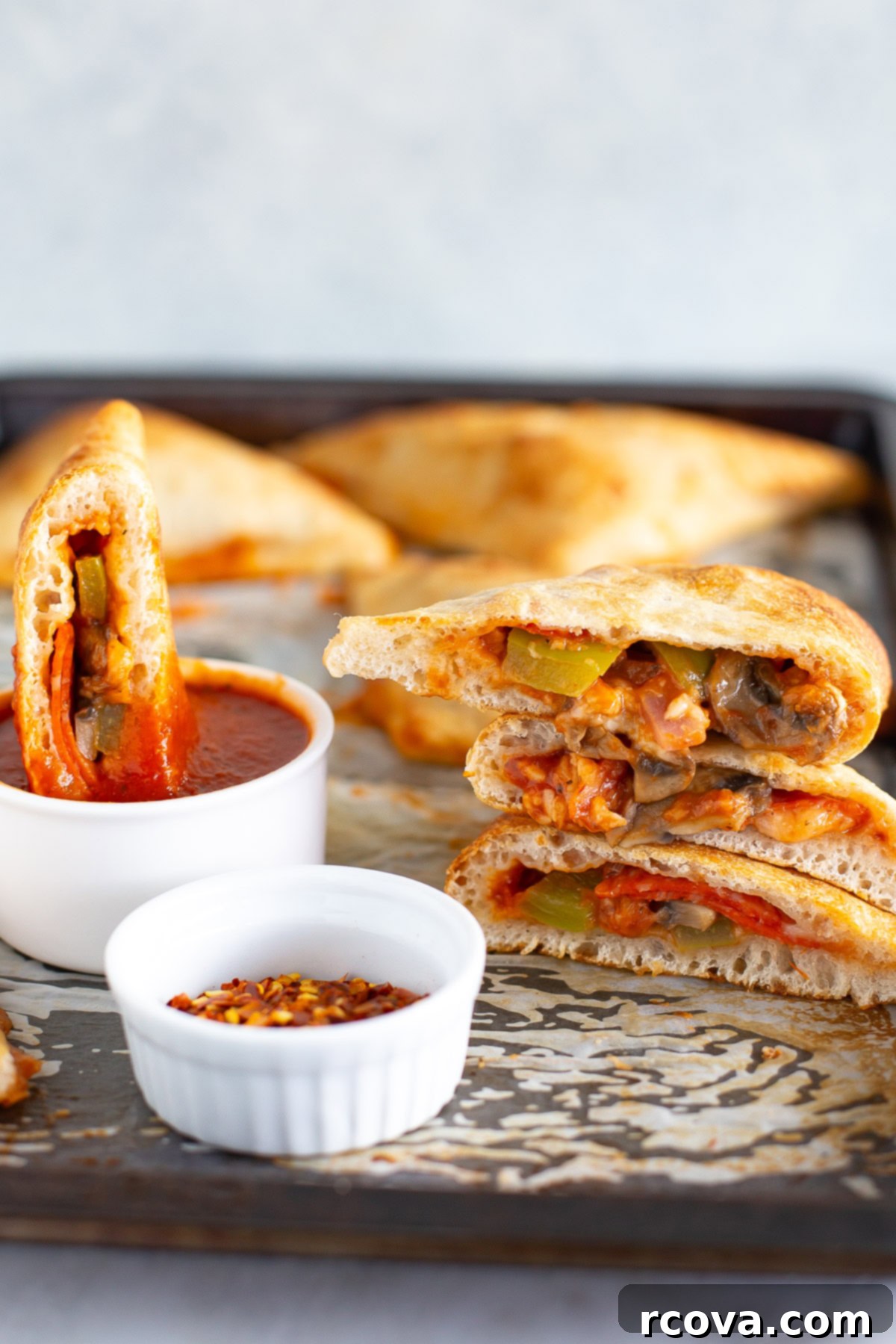 Prep-Ahead & Relax: Easy Camping Meals for Your Vacation 17 Homemade pizza pockets with a side of red chili flakes and extra marinara