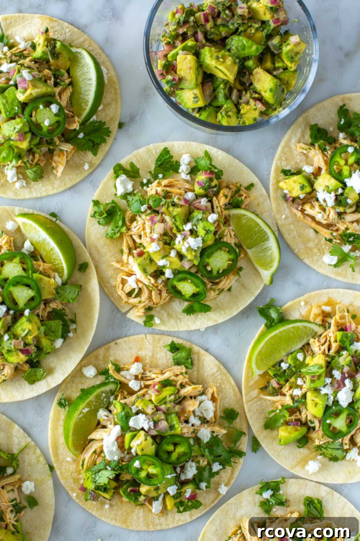 Prep-Ahead & Relax: Easy Camping Meals for Your Vacation 19 Multiple cilantro lime chicken tacos topped with avocado salsa and feta cheese.