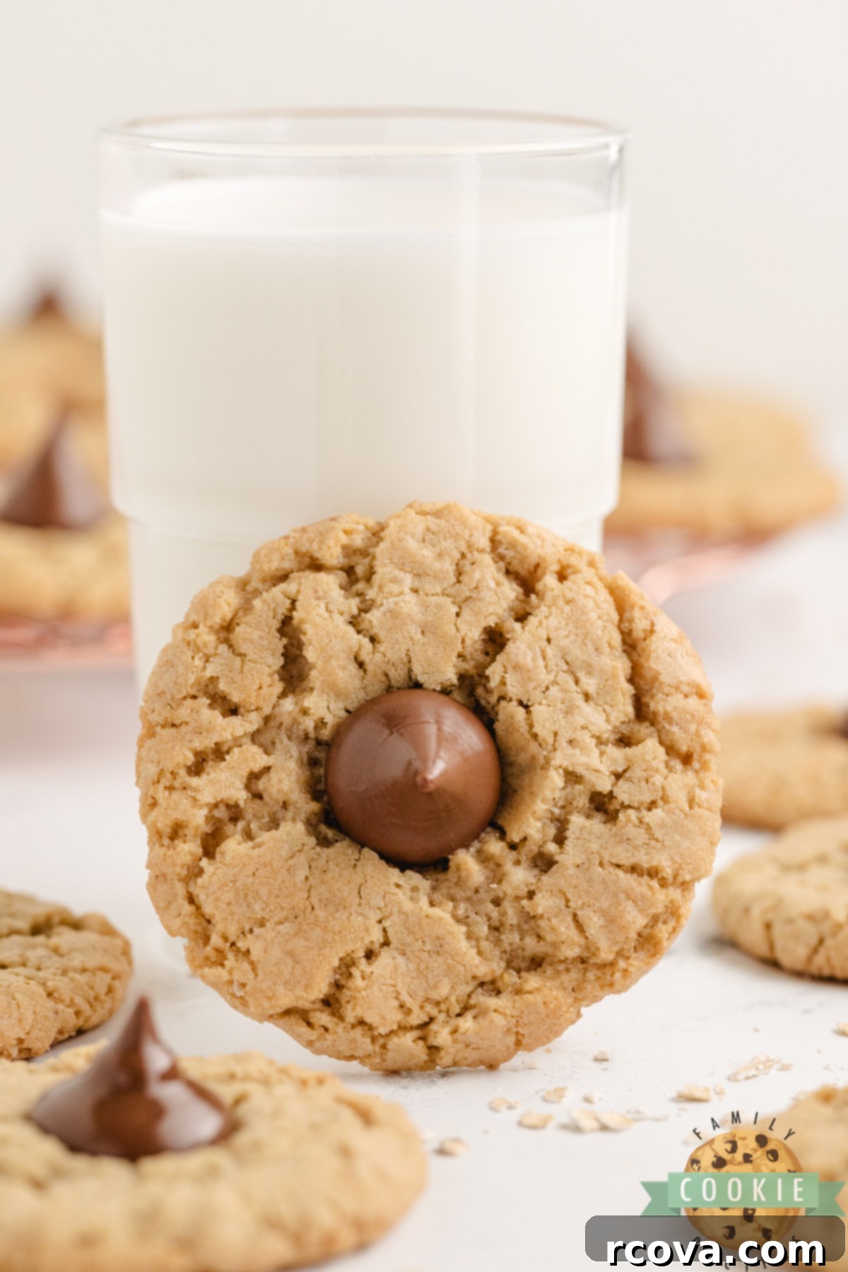 Chewy Oatmeal Kiss Cookies 7 Glass of milk with an oatmeal cookie topped with a Hershey kiss.
