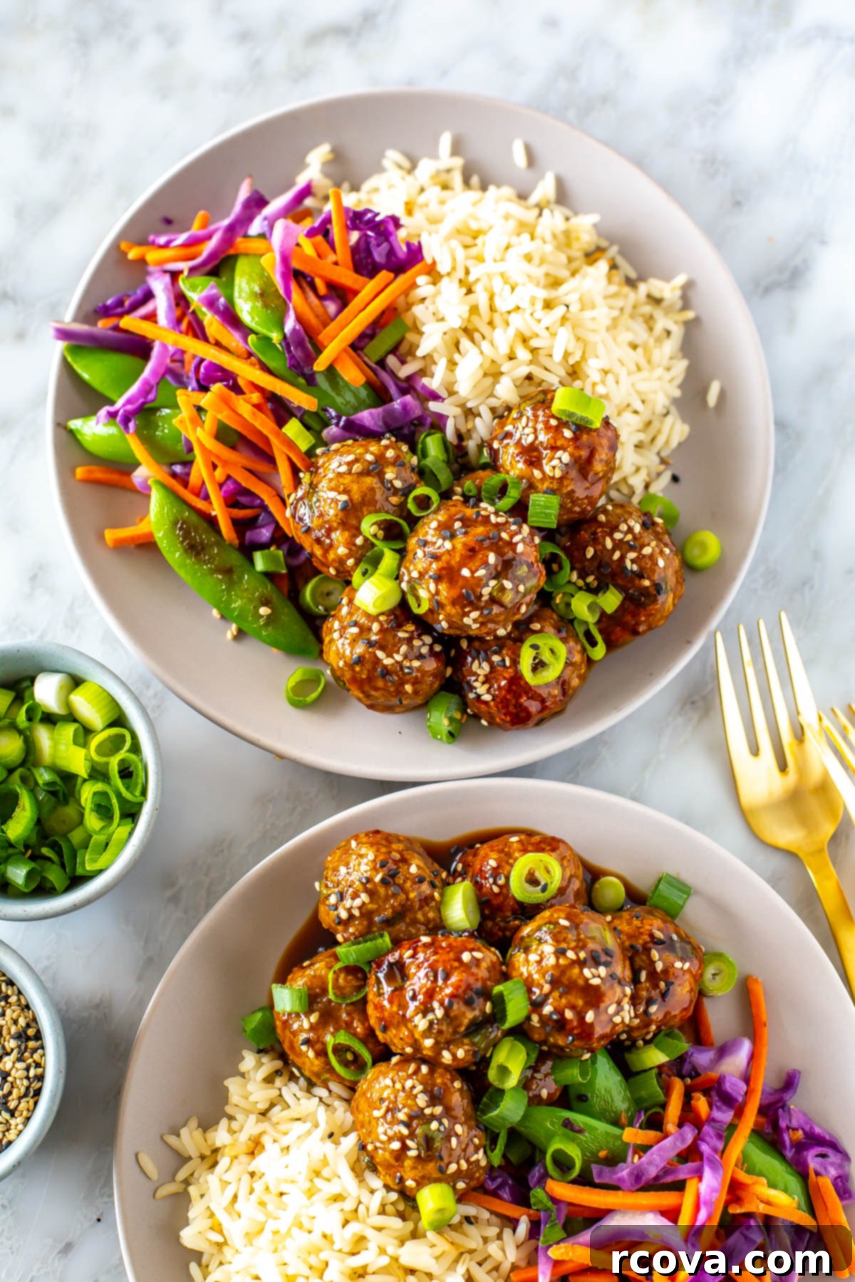 Sticky Teriyaki Chicken Bites 9 Two bowls with a bed of rice, side of stir fried veggies and sticky teriyaki chicken meatballs.