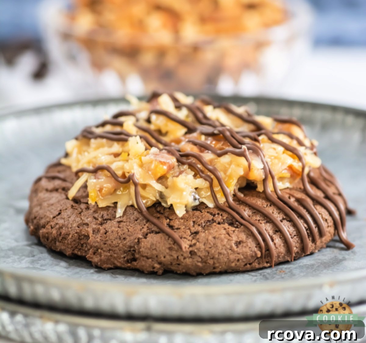 Decadent German Chocolate Cake Cookies Crumbl Style 2 Crumbl Copycat German Chocolate Cake Cookies are rich, soft chocolate cookies topped with gooey coconut pecan frosting and a sweet drizzle, displayed beautifully on a plate.