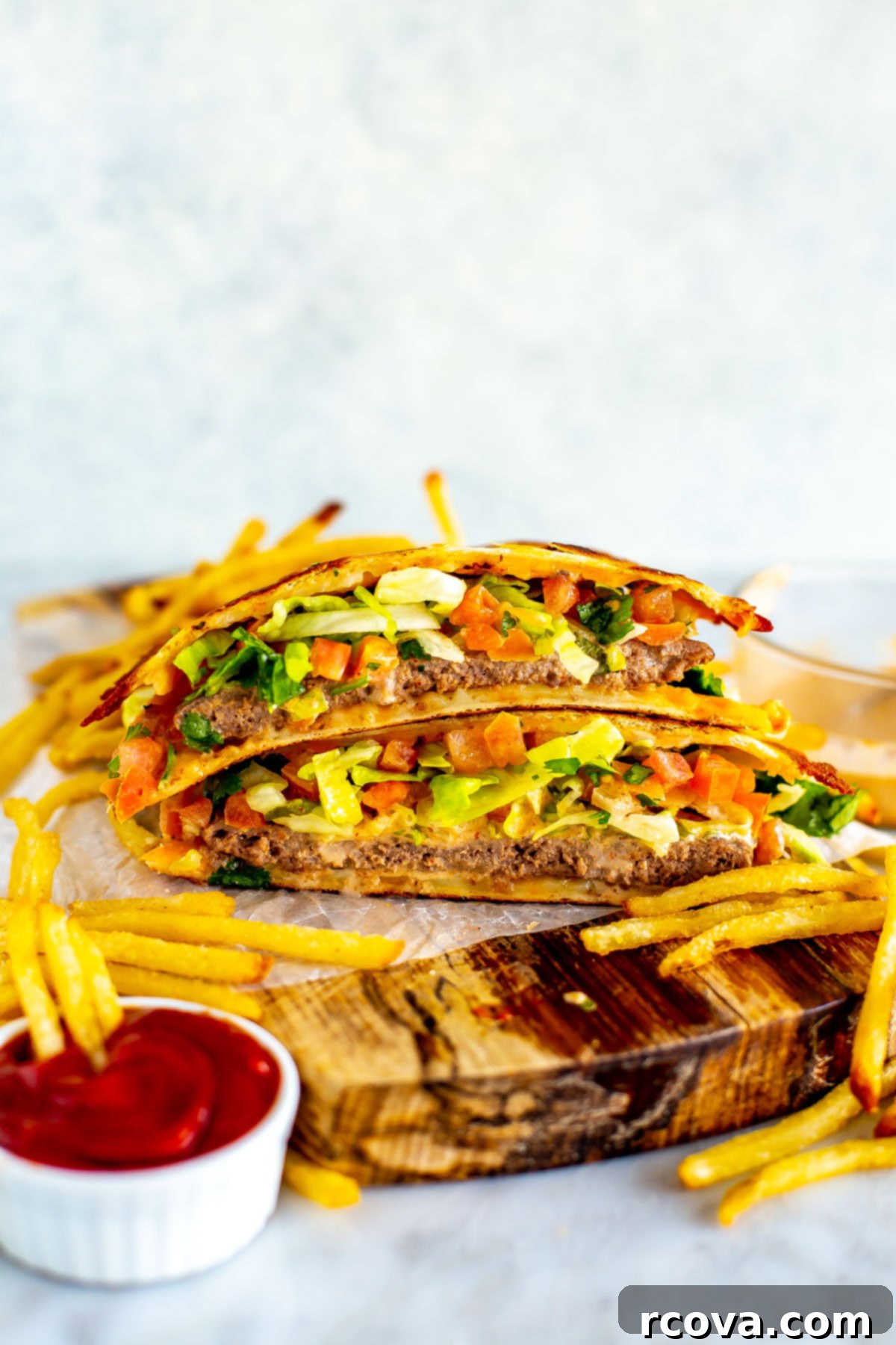 28 Wholesome and Simple Ground Beef Meals 14 A quesadilla burger cut open on a butcher block.