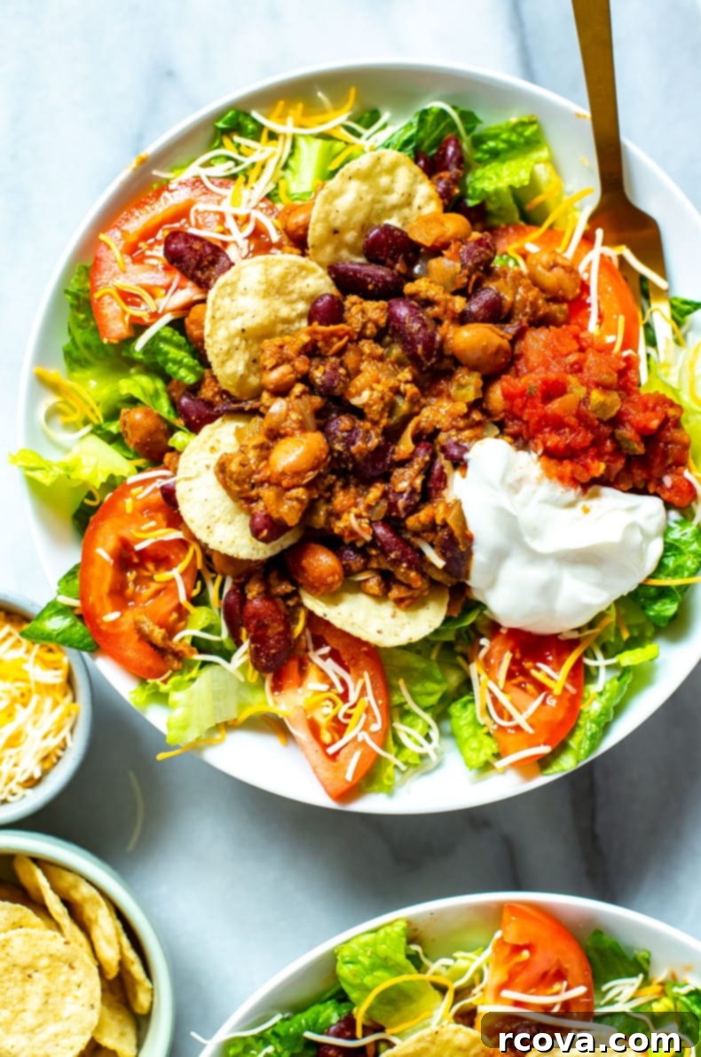 28 Wholesome and Simple Ground Beef Meals 31 A close-up of a bowl of Copycat Wendy's Taco Salad with a fork in it.