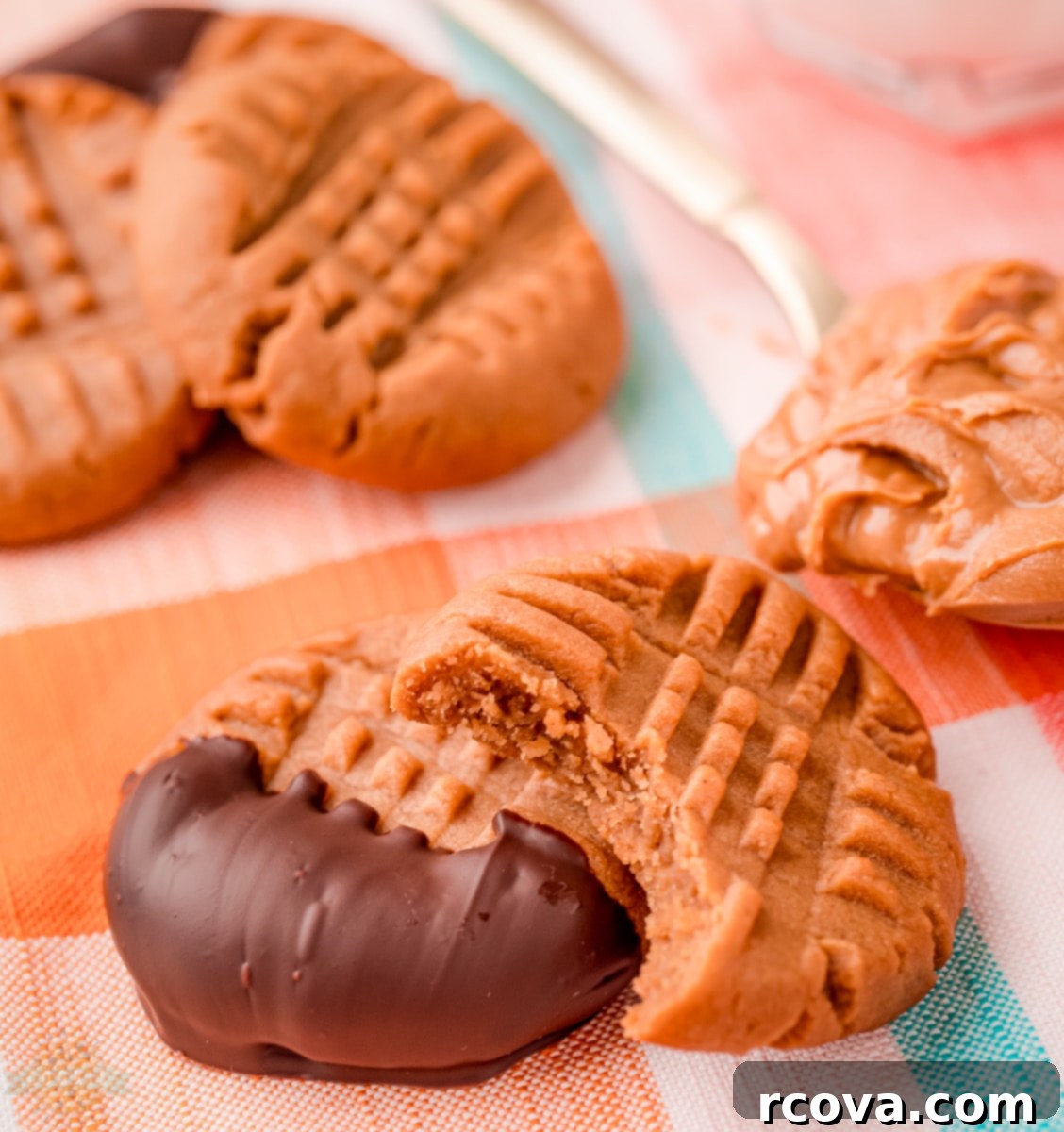 Low Carb Peanut Butter Cookies 7 Stack of keto peanut butter cookies with a bite taken out, showing texture