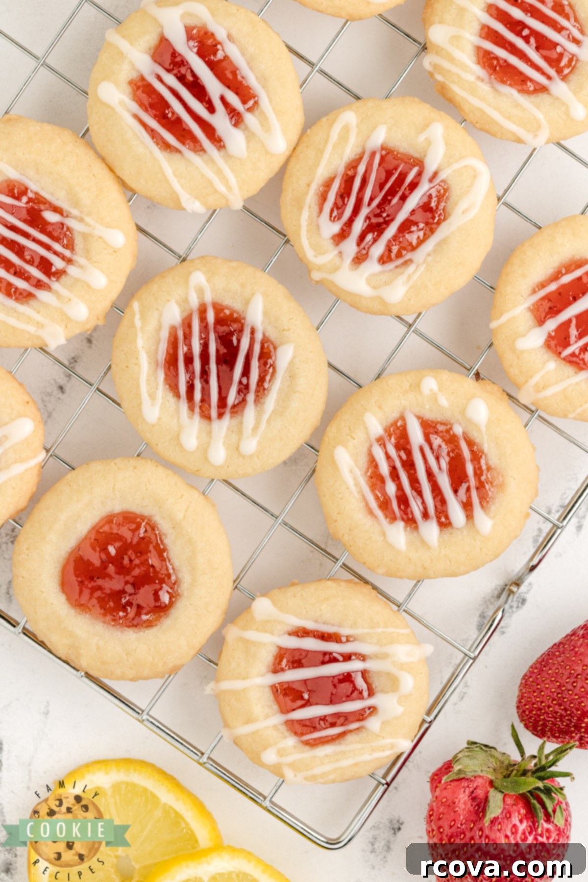 Strawberry Lemon Drop Cookies 3 Close-up of lemon thumbprint cookies with a strawberry filling and golden edges.