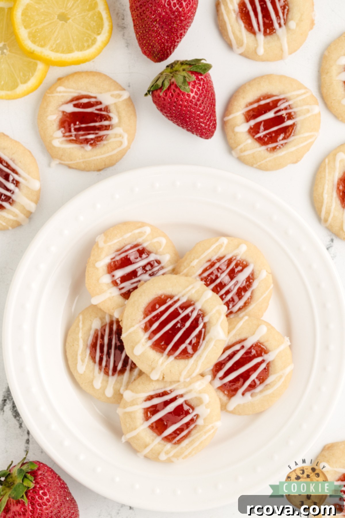 Strawberry Lemon Drop Cookies 5 Close-up of baked Strawberry Lemon Thumbprint Cookies with strawberry filling and lemon glaze, ready to eat.