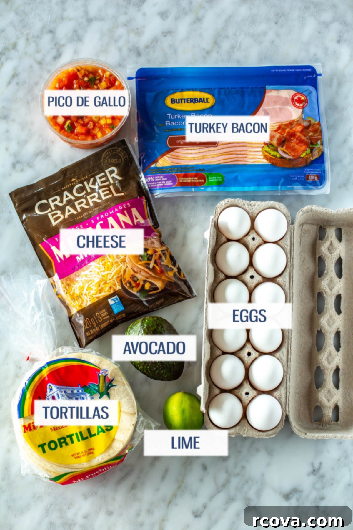 The Ultimate 30-Minute Breakfast Tacos 4 A colorful flat lay showing all the fresh ingredients required for delicious breakfast tacos: vibrant pico de gallo, crispy turkey bacon, shredded cheddar cheese, fluffy eggs, ripe avocado, soft corn tortillas, and a fresh lime for garnish.