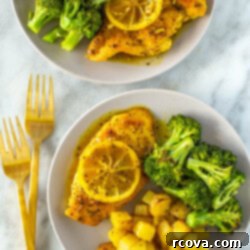 Tangy & Tender Lemon Pepper Chicken 11 Two plates with lemon pepper chicken and a side of roasted potatoes and roasted broccoli.