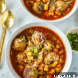 Your New Favorite Turkey Meatball Soup 11 Two bowls of Italian turkey meatball soup with spoons beside them.