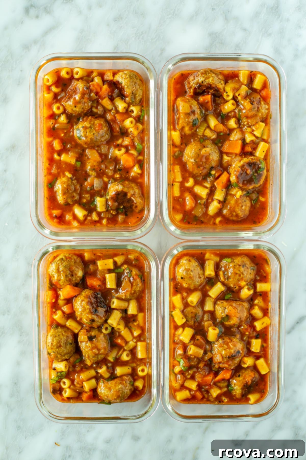 Your New Favorite Turkey Meatball Soup 10 Four individual glass meal prep containers filled with servings of Italian Turkey Meatball Soup, ready for refrigeration or freezing.