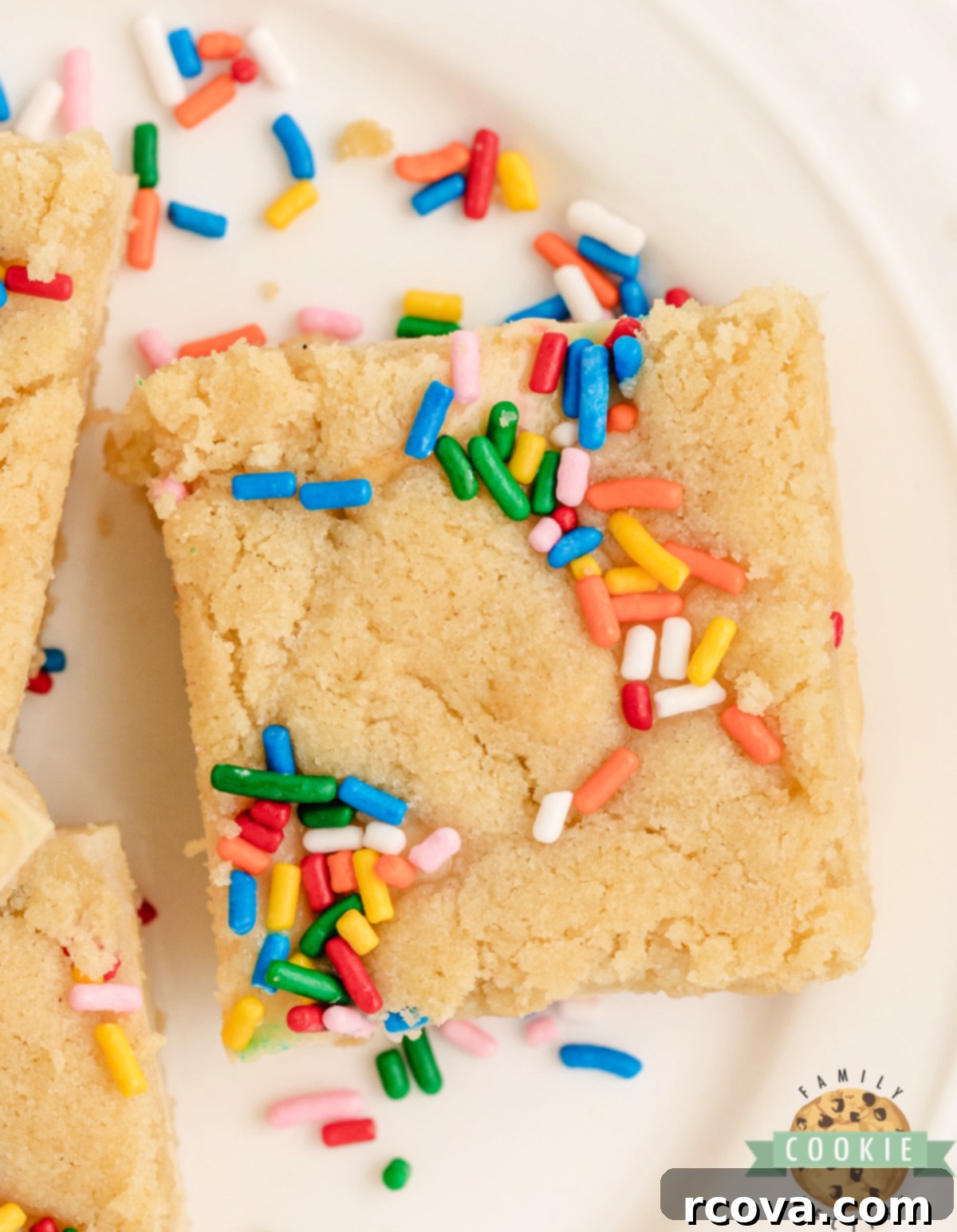 Sugar Cookie Cheesecake Bars 6 Sugar cookie bars with a cheesecake filling and sprinkles.