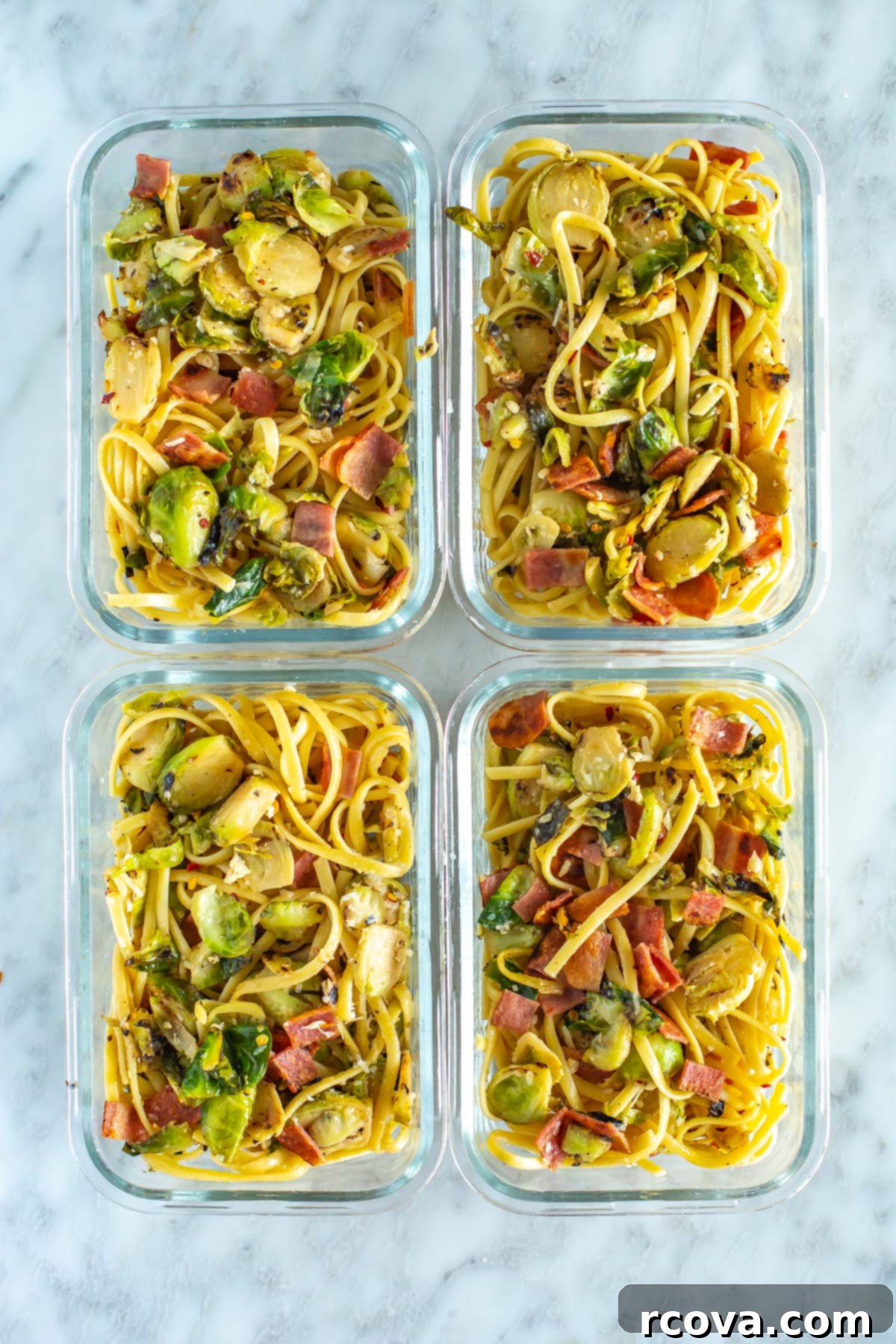 Bacon Brussels Sprouts Creamy Pasta 8 Four perfectly portioned meal prep containers, each filled with creamy brussels sprouts pasta and bacon, ready for convenient lunches or dinners throughout the week, showcasing its suitability for meal planning.