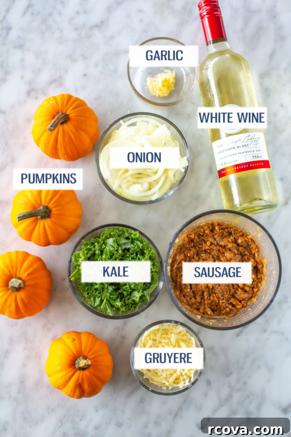 Unutulmaz Balkabağı Dolması Tarifi 4 A vibrant flat lay image showcasing all the fresh ingredients needed for making stuffed pumpkins: whole mini pumpkins, a chopped yellow onion, fresh garlic cloves, a bottle of white wine, a bunch of fresh kale, ground turkey, a small bowl of Gruyere cheese, and various spices.