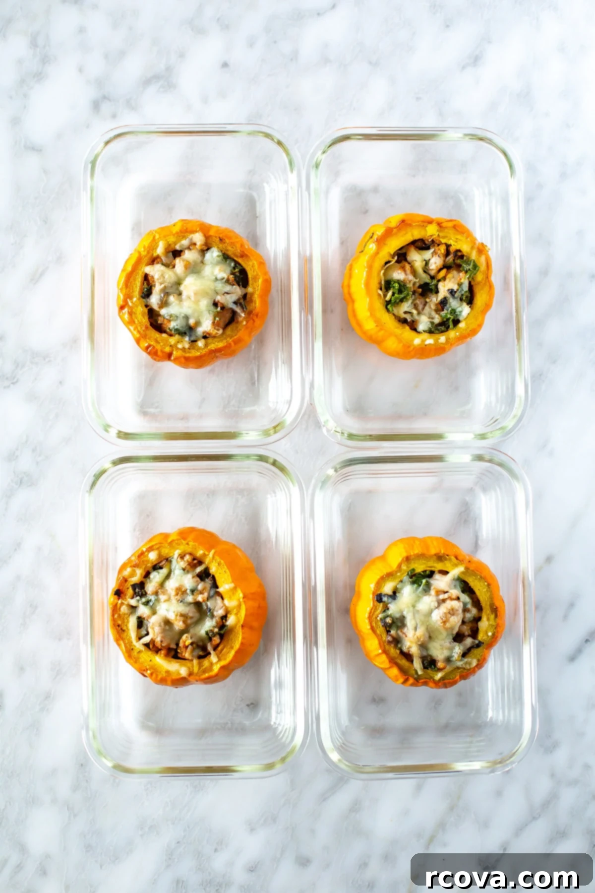 Unutulmaz Balkabağı Dolması Tarifi 10 Four individual meal prep containers, each holding a perfectly portioned mini stuffed pumpkin, ready for storage and future enjoyment.