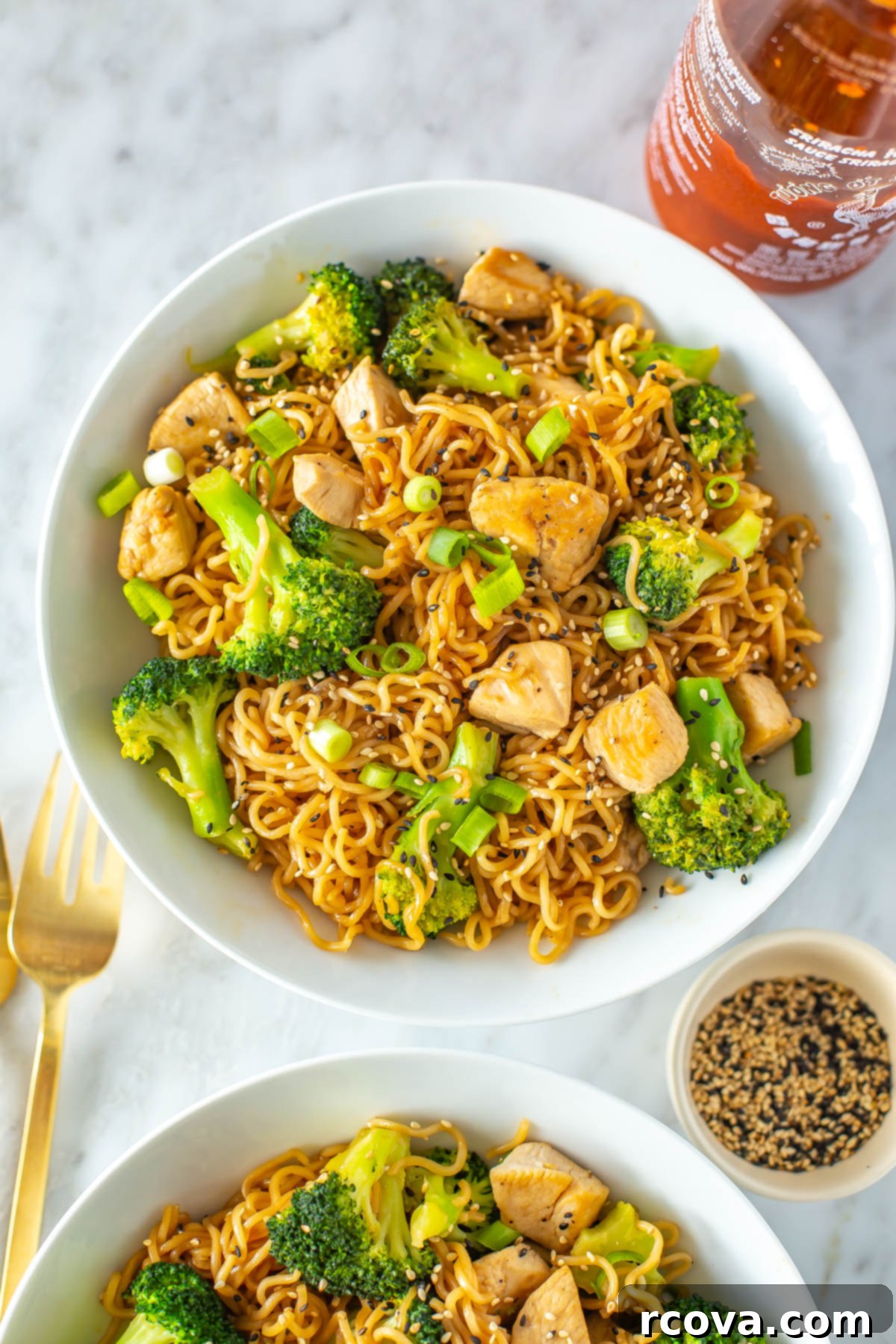 Effortless 30-Minute Chicken Ramen Stir Fry 9 A close-up of a perfectly portioned bowl of chicken ramen stir fry, garnished with green onions and sesame seeds.