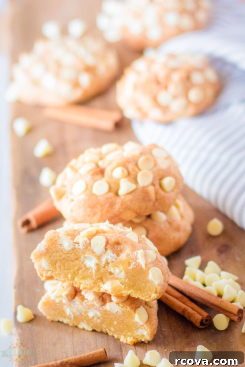 Thick and Chewy Snickerdoodle Cookies 8 Two soft and chewy giant white chocolate snickerdoodle cookies, one broken in half to show the texture and white chocolate chips.