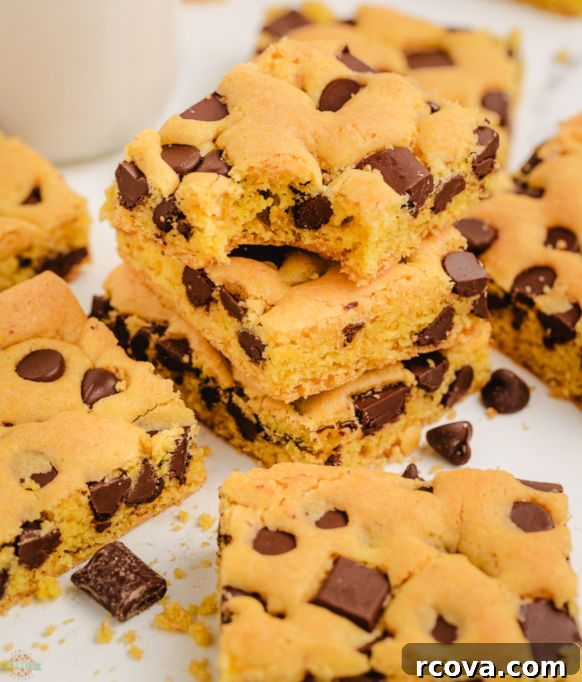 Golden Cake Mix Cookie Bar Delights 7 A close-up of a chocolate chip cookie bar with a bite taken out, showcasing its moist, rich interior and perfectly melted chocolate, highlighting its delicious chewiness.