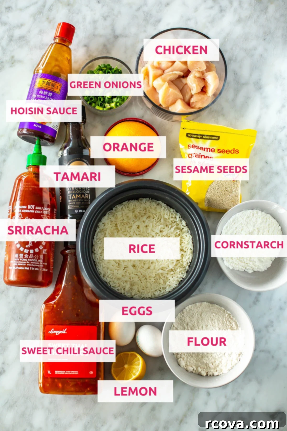 Quick Mandarin Chicken Delight 4 A vibrant flat lay of all the fresh ingredients needed for Mandarin chicken: hoisin sauce, bright green onions, diced chicken breast, tamari, a whole orange, sesame seeds, sriracha, uncooked jasmine rice, cornstarch, flour, eggs, a fresh lemon, and sweet chili sauce.