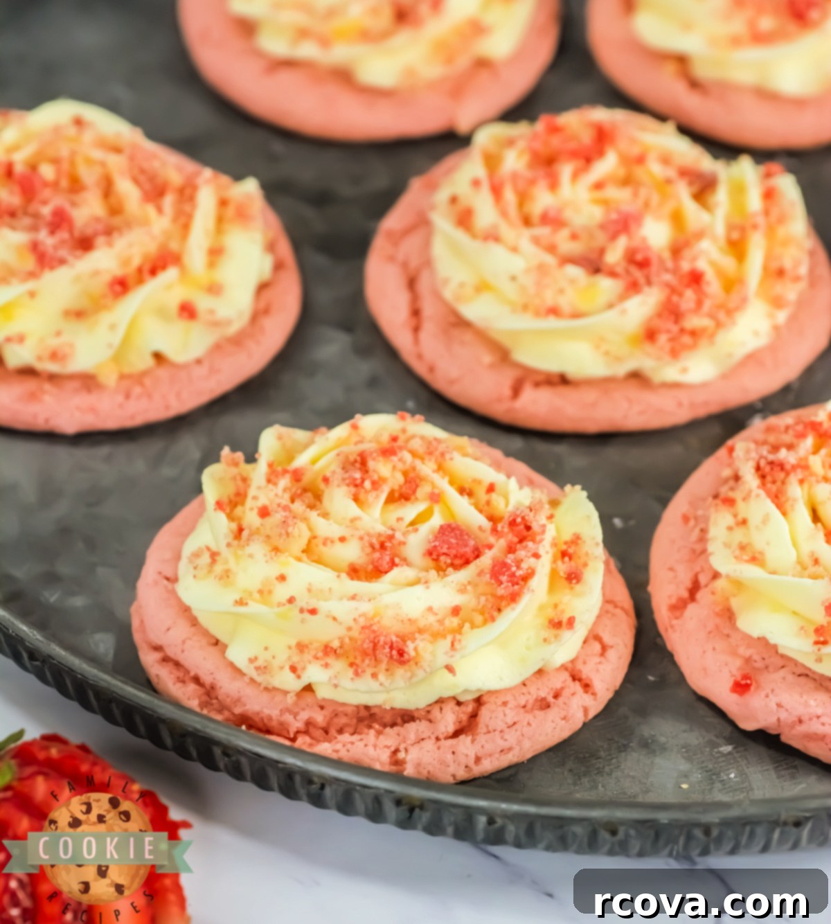 Bakery Style Strawberry Shortcake Cookies 9 A tray of beautifully decorated Copycat Crumbl Strawberry Shortcake Cookies, featuring piped vanilla frosting and streusel.