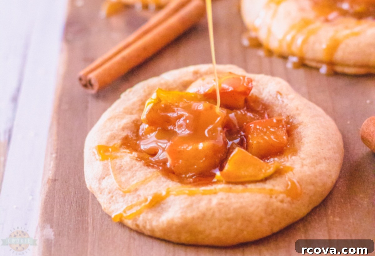 Spiced Apple Pie Gems 2 Close-up of a golden brown Caramel Apple Pie Cookie with visible apple filling and caramel drizzle.