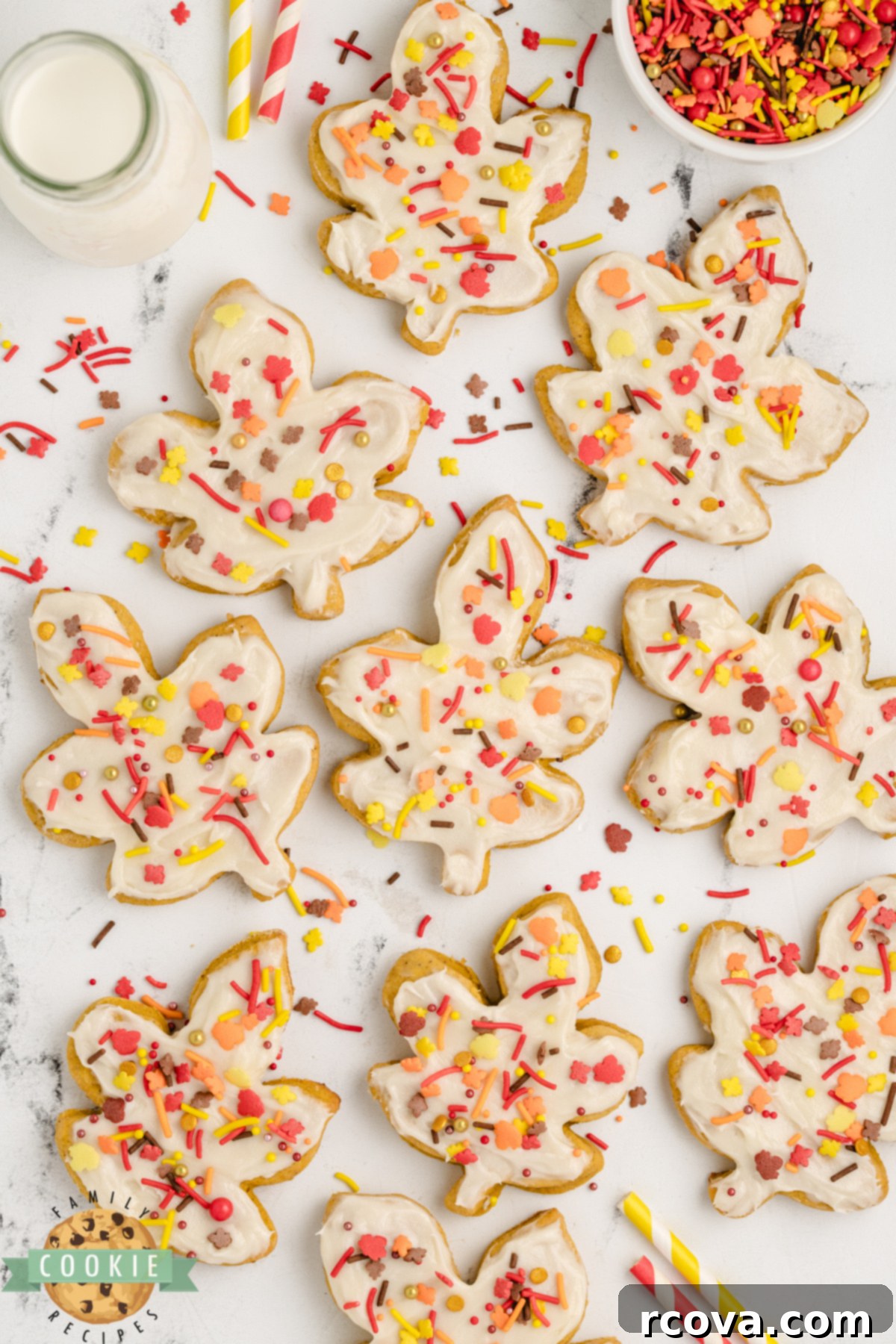 Harvest Pumpkin Sugar Cookie Delights 5 Overhead view of frosted Pumpkin Sugar Cookies ready to serve on a platter, adorned with sprinkles.