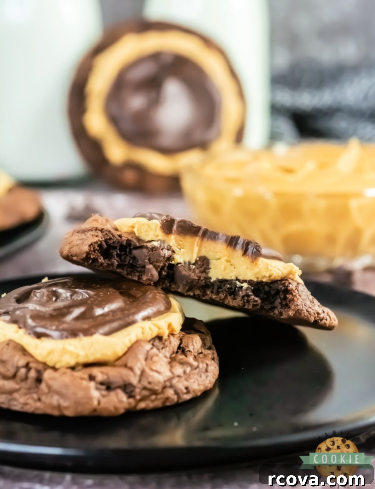 Peanut Butter Fudge Brownie Cookies 6 A Crumbl Copycat Buckeye Brownie Cookie cut in half, showcasing its thick fudgy chocolate base, generous peanut butter layer, and smooth ganache.