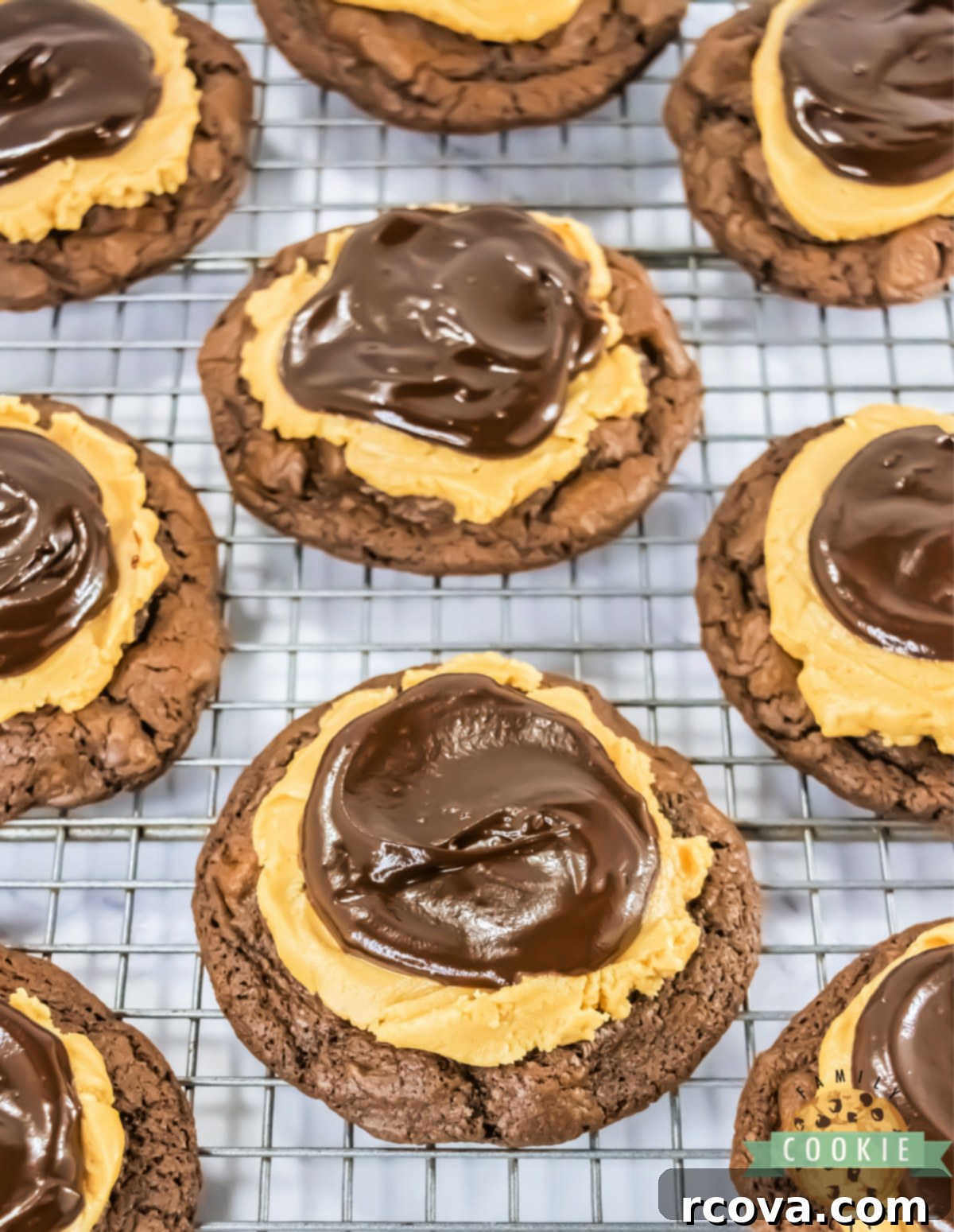 Peanut Butter Fudge Brownie Cookies 9 Close-up of a Crumbl Copycat Buckeye Brownie Cookie on a cooling rack, showcasing its perfect ganache and rich layers.