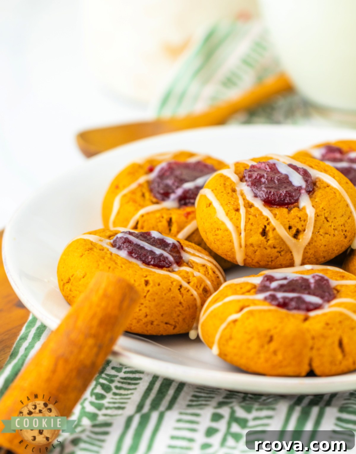Sweet & Spicy Gingerbread Thumbprints 5 White chocolate drizzled Gingerbread Thumbprint Cookies on a white plate