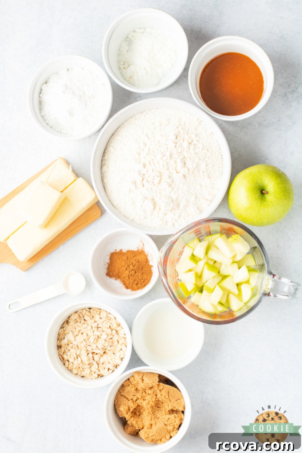 Spiced Apple Crumble Cookies 3 A selection of fresh ingredients including flour, butter, apples, and spices for making Apple Crumble Cookies.