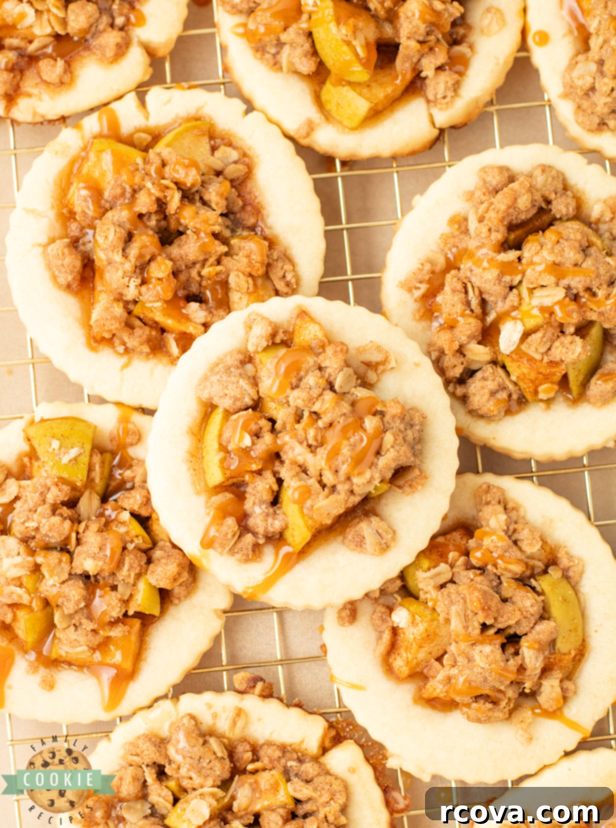 Spiced Apple Crumble Cookies 7 Shortbread cookies topped with cinnamon apples and a crumbly oat topping, ready to be enjoyed.
