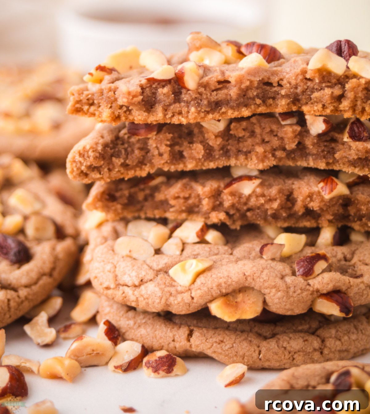 Decadent Chocolate Hazelnut Cookies 4 A chocolate hazelnut cookie broken in half, revealing its soft interior and the Nutella swirl within.