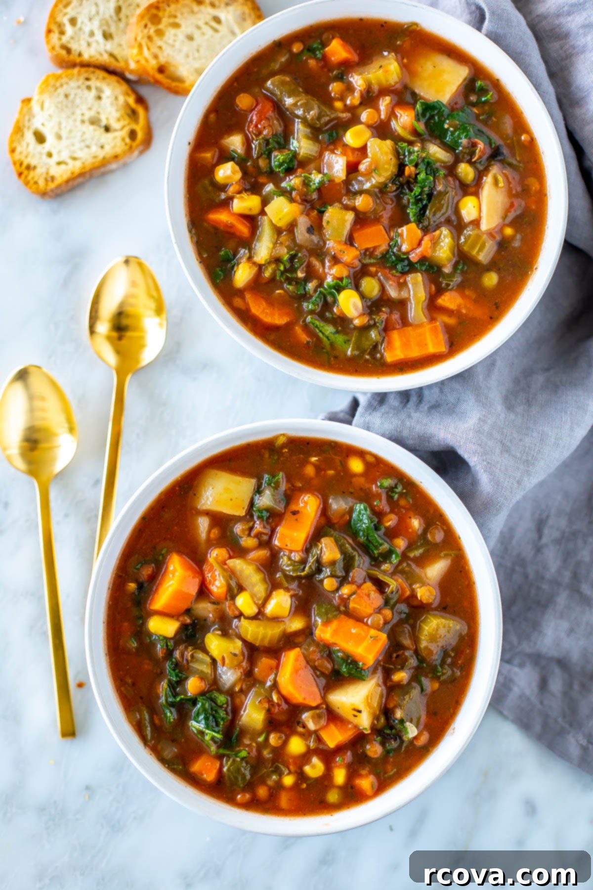Comforting Crockpot Vegetable Soup 2 Two steaming bowls of hearty crockpot vegetable soup, garnished with fresh herbs, with spoons on the side. The scene is cozy and inviting, highlighting the soup's appeal.