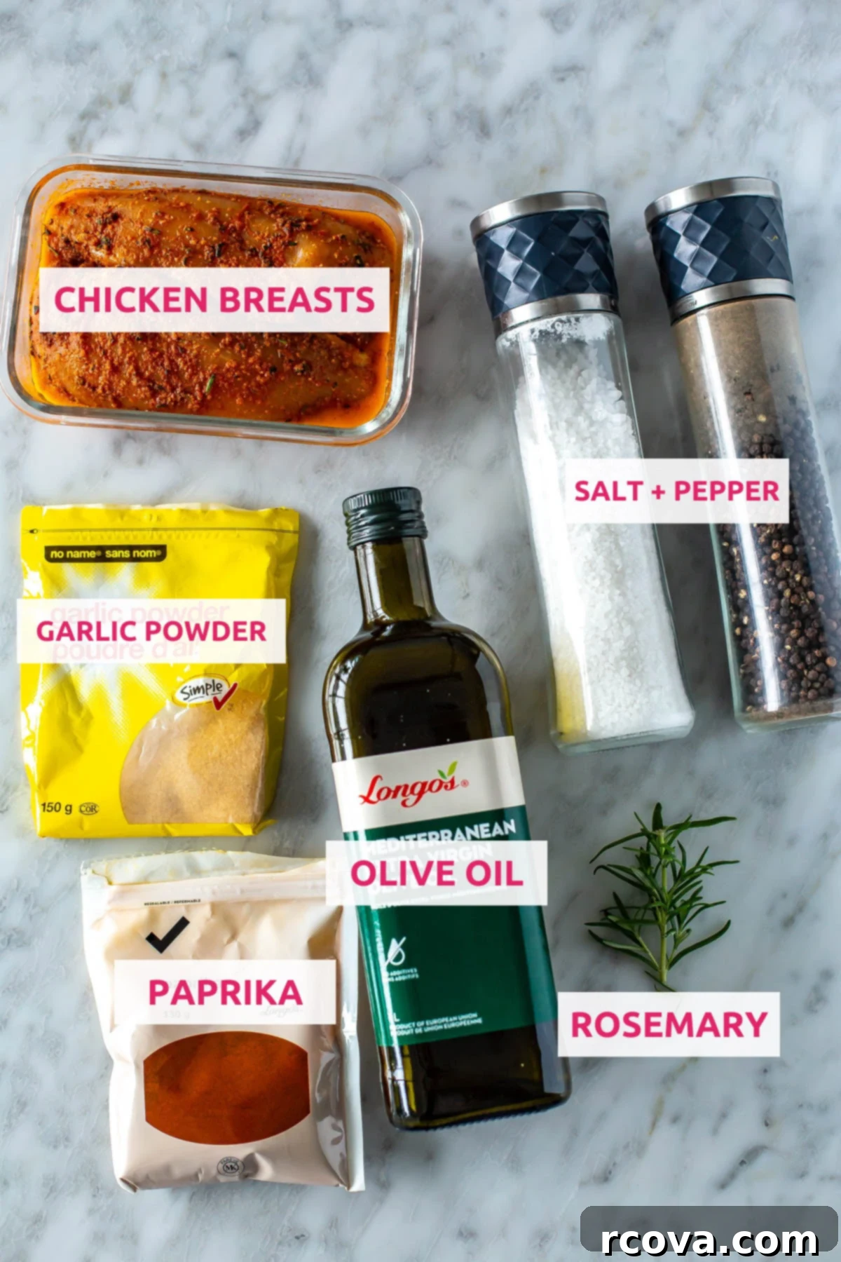 Perfect Air Fryer Chicken Breasts The Ultimate Marinade 4 Ingredients for air fryer chicken breasts: chicken breasts, garlic powder, paprika, olive oil, fresh rosemary, salt and pepper arranged on a wooden board.