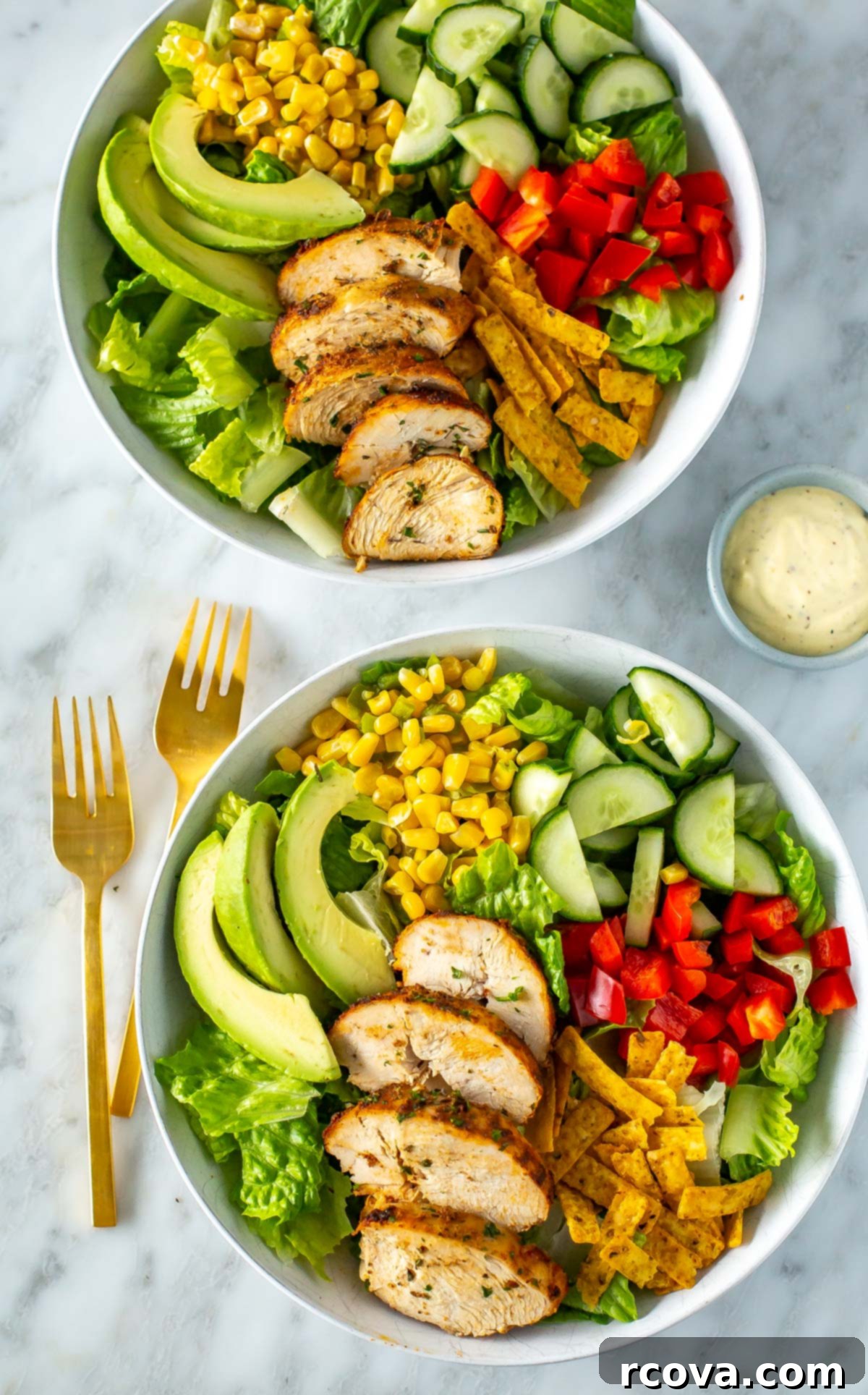 Perfect Air Fryer Chicken Breasts The Ultimate Marinade 7 Two bowls of salad with perfectly sliced air fryer chicken breasts on top, ready to be enjoyed.