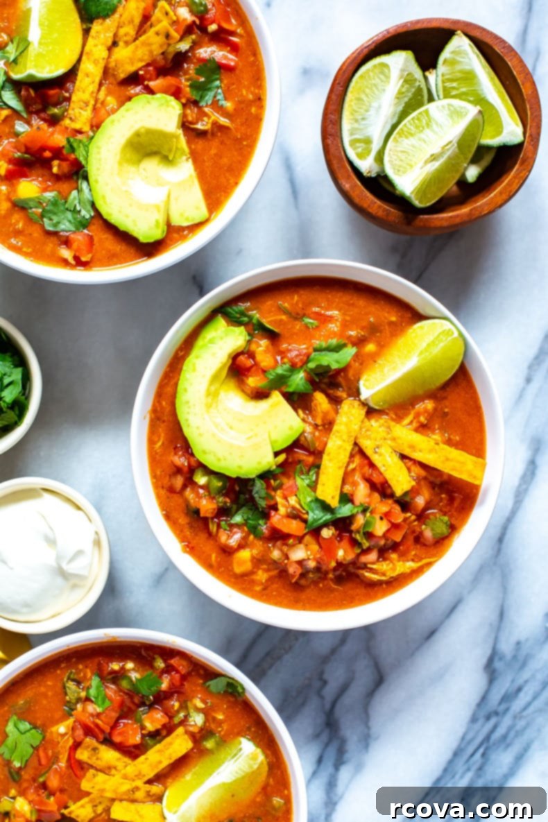 26 Easy and Healthy Pantry Dinners 22 Three bowls of Instant Pot chicken enchilada soup with sour cream and cilantro on the side.