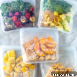 5 Genius Make Ahead Smoothie Packs 14 Five different meal prep smoothie packs in freezer bags, neatly arranged for freezer storage, showcasing various fruit and vegetable combinations.